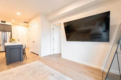 a living room with a large flat screen tv on a wall at Hollywood Palladium 1 BD EV charger Free Parking in Los Angeles