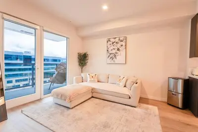 a living room with a couch and a large window at Hollywood Palladium 1 BD EV charger Free Parking in Los Angeles