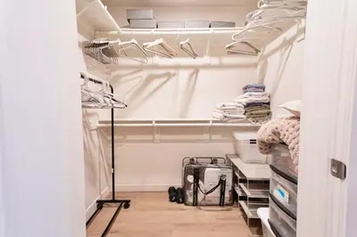 a walk in closet with white walls and white shelves at Hollywood Palladium 1 BD EV charger Free Parking in Los Angeles