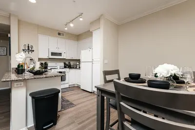a kitchen and dining room with a table and chairs at Stylish Glendale Retreat by Americana & Galleria in Glendale