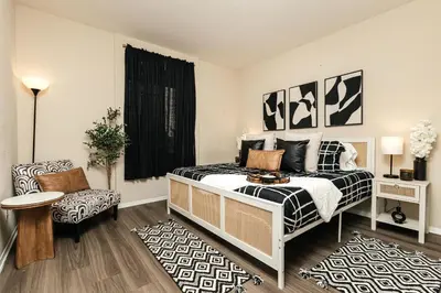 a bedroom with a bed and a chair at Stylish Glendale Retreat by Americana & Galleria in Glendale