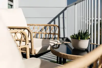 a balcony with a chair and a plant in a vase at Penthouse Muse, West Hollywood, Los Angeles in Los Angeles