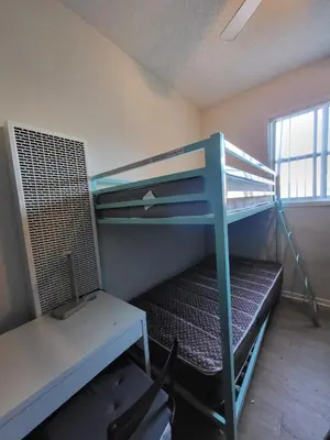 a bunk bed in a room with a desk and bunk beds at Sunny LA Bunk Bed in Los Angeles