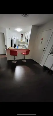 an empty kitchen with two red chairs in a room at Sunny LA Bunk Bed in Los Angeles