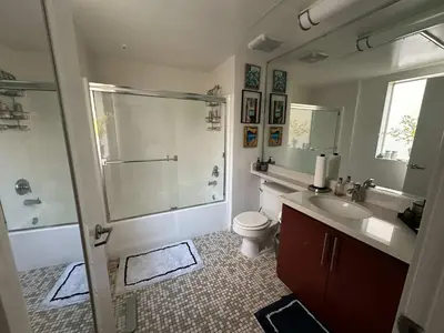 a bathroom with a shower and a toilet and a sink at Walk to Beach & Promenade Cozy Santa Monica Condo in Los Angeles