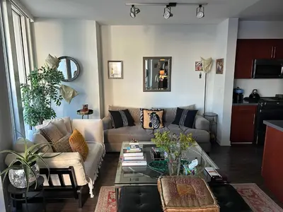 a living room with a couch and a glass table at Walk to Beach & Promenade Cozy Santa Monica Condo in Los Angeles