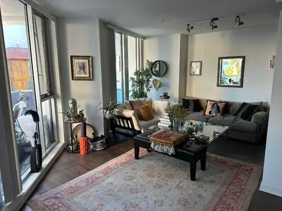 a living room with a couch and a table at Walk to Beach & Promenade Cozy Santa Monica Condo in Los Angeles