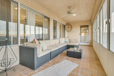 a screened in porch with a couch and a table at Golf, Fish and More! Peaceful Home in Helendale in Helendale