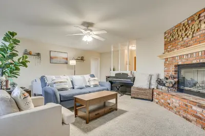 a living room with a couch and a fireplace at Golf, Fish and More! Peaceful Home in Helendale in Helendale