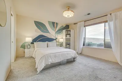 a bedroom with a bed and a large window at Golf, Fish and More! Peaceful Home in Helendale in Helendale