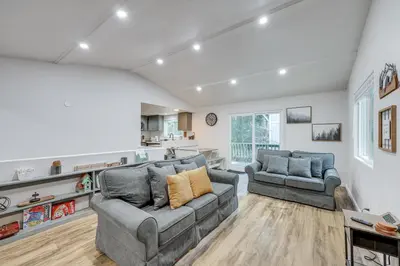 a living room with two couches and a kitchen at 1 Mi to Lake Gregory! Updated Family Home with Deck in Crestline