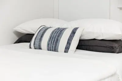 a pile of pillows sitting on top of a bed at Peaceful 2BD Home in WeHo in Los Angeles
