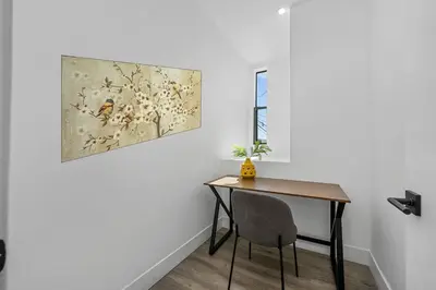 a table and chair in a room with a painting on the wall at 2BR 2BA Villa in Melrose with Free Parking in Los Angeles