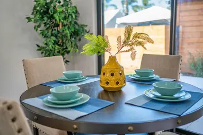 a table with a yellow vase on top of it at 2BR 2BA Villa in Melrose with Free Parking in Los Angeles