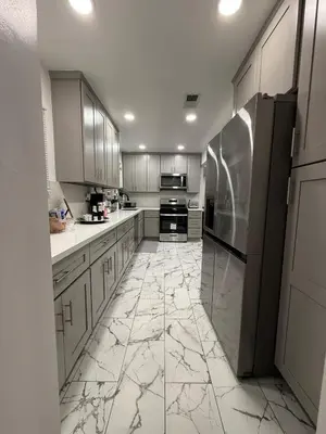 a kitchen with marble floors and stainless steel appliances at Modern2BR Home SoFi LAX Parking Fast WiFi in Los Angeles