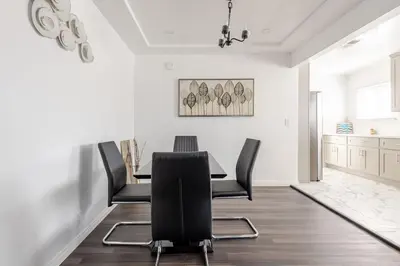 a dining room with a table and black chairs at Modern2BR Home SoFi LAX Parking Fast WiFi in Los Angeles