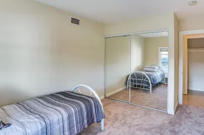 a bedroom with a bed and a mirror at 5 Mi to Anaheim Convention Center Retreat with Yard in Anaheim