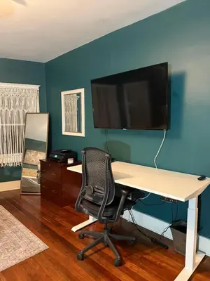 an office with a desk and a tv on a blue wall at Family gateway in the heart of Los Angeles 2bedroom 2bath backyard in Los Angeles