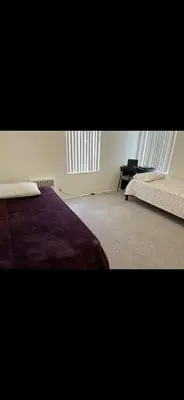 a bedroom with two beds and a desk in it at Shared but isolated room in a shared soace in Los Angeles