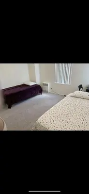 a bedroom with two beds and a window in it at Shared but isolated room in a shared soace in Los Angeles