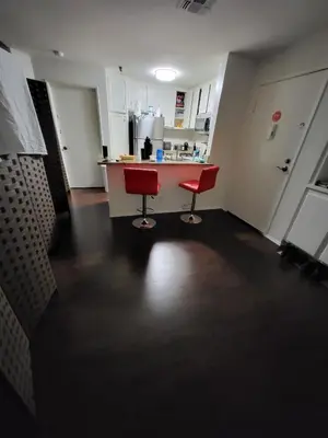 a kitchen with two red chairs and a counter at Shared but isolated room in a shared soace in Los Angeles