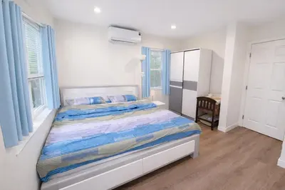 a bedroom with a bed with blue and white sheets at Brand new private Home with Yard free parking, near Ontario airport in Ontario