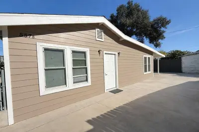 a house with a garage with a driveway at Brand new private Home with Yard free parking, near Ontario airport in Ontario