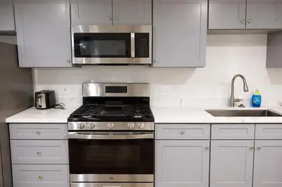 a kitchen with a stove and a microwave at Brand new private Home with Yard free parking, near Ontario airport in Ontario