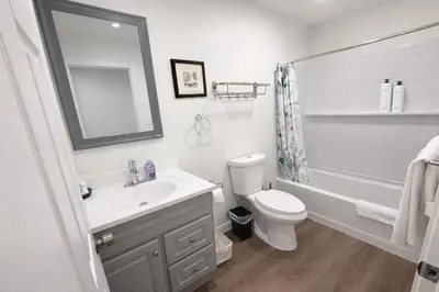 a bathroom with a sink and a toilet and a mirror at Brand new private Home with Yard free parking, near Ontario airport in Ontario