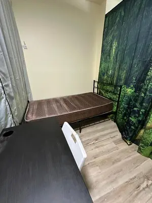 a room with two beds and a table at Shared but isolated room in Central Los Angeles in Los Angeles