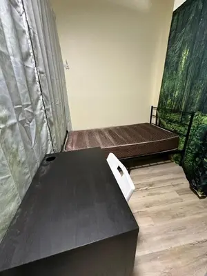 a room with two beds and a table at Shared but isolated room in Central Los Angeles in Los Angeles