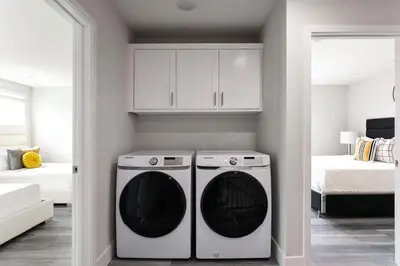 a kitchen with a washer and dryer in a room at Relax in Spacious 4BR Home Sleeps 8 with Parking in North Hollywood