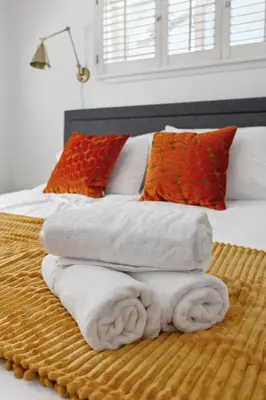 a bedroom with a bed with towels on it at Heated Pool Oasis Close to Attractions in Encino