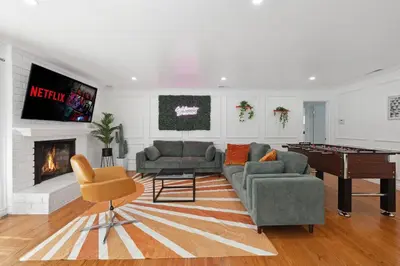a living room with a couch and a pool table at Heated Pool Oasis Close to Attractions in Encino