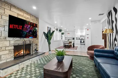 a living room with a couch and a fireplace at Stylish Getaway with Hot Tub in Northridge Hospital Heliport