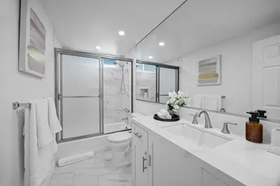 a white bathroom with a shower and a toilet at Stylish Getaway with Hot Tub in Northridge Hospital Heliport