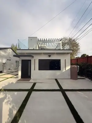 a small white house with a driveway at SkyLoft in Woodland Hills