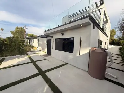 a large white house with a driveway with at SkyLoft in Woodland Hills