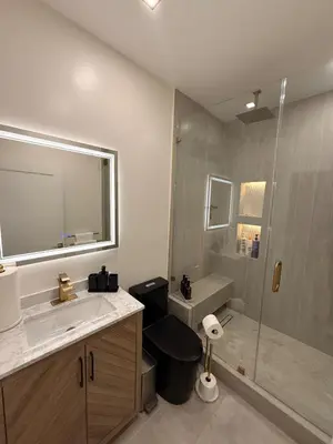 a bathroom with a toilet and a sink and a shower at SkyLoft in Woodland Hills