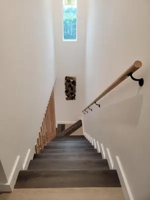 a staircase in a house with white walls and wooden floors at Spacious 2-Bedroom, One and a Half Bath Home in Pico-Robertson Near Beverly Hills and Cedars-Sinai in Los Angeles