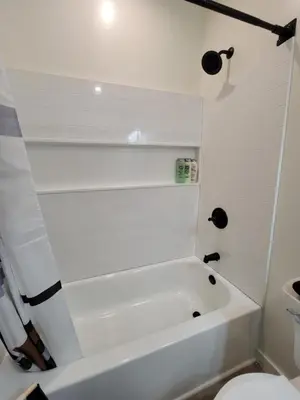 a white bathroom with a tub and a toilet at Spacious 2-Bedroom, One and a Half Bath Home in Pico-Robertson Near Beverly Hills and Cedars-Sinai in Los Angeles