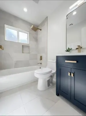a bathroom with a toilet and a tub and a sink at stunning Poolside villa