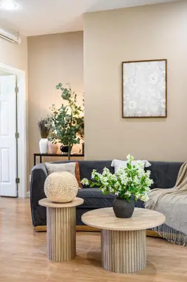 a living room with a couch and two tables at Modern Cozy Stay w Outdoor Patio & Grill in Pomona