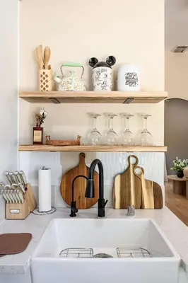 a kitchen counter with a sink and wooden shelves at Modern Cozy Stay w Outdoor Patio & Grill in Pomona