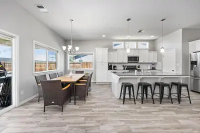 a kitchen with a table and chairs and a counter at Spacious Home with Private Pool in Bakersfield