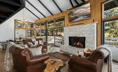 a living room with leather furniture and a fireplace at Beautiful Wrightwood Chalet in Wrightwood