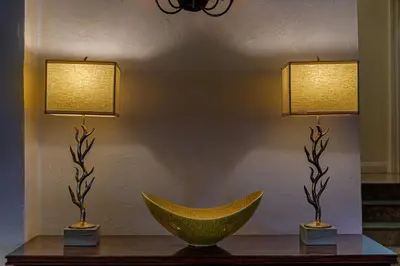 two lamps on a table with a bowl on it at The Sovereign in Los Angeles