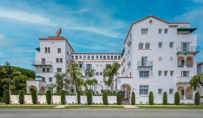 a white building with a fence in front of it at The Sovereign in Los Angeles