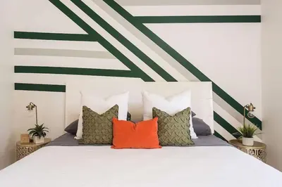 a bedroom with a bed with colorful pillows at Stylish Home Prime Location with Fireplace & Patio in Los Angeles