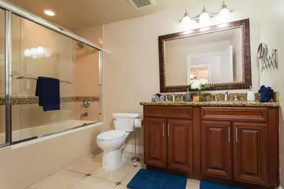 a bathroom with a toilet and a shower and a mirror at Stylish Home Prime Location with Fireplace & Patio in Los Angeles